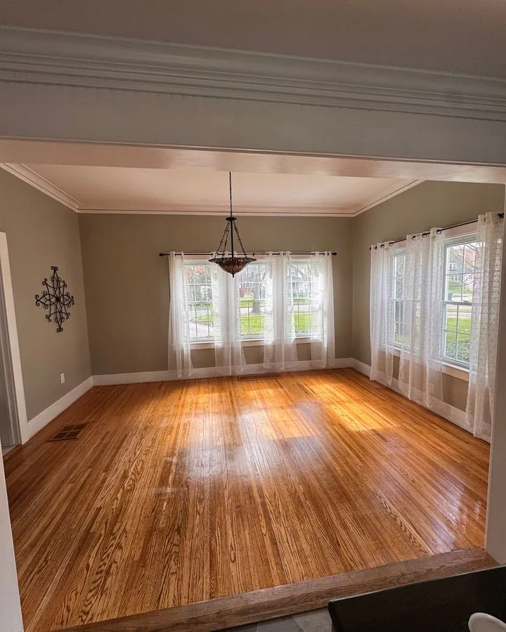 Empty dining room with polished hardwood floor, ready for move-out