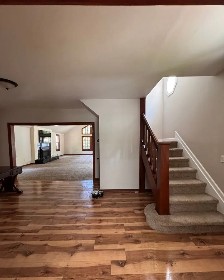 Empty entry hall and staircase with polished floors