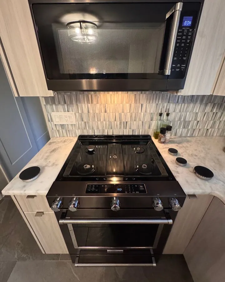 Kitchen gas range and microwave with marble counters