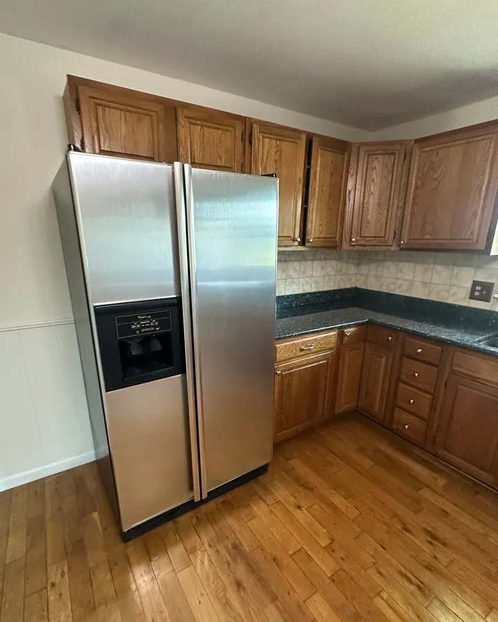 Kitchen with wood cabinets and a stainless refrigerator