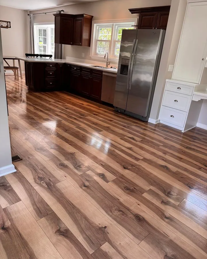 Kitchen with shining plank floors and stainless appliances