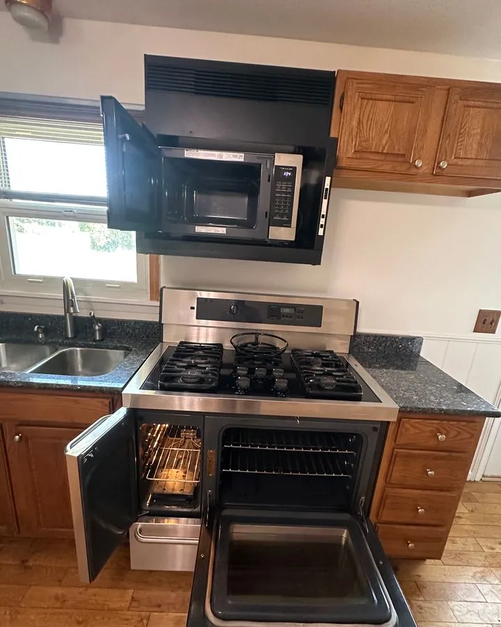 Kitchen with the oven and microwave opened after cleaning