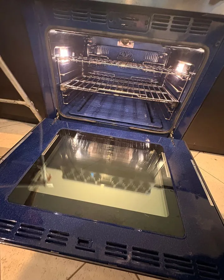 Inside of an oven with racks and glass door cleaned