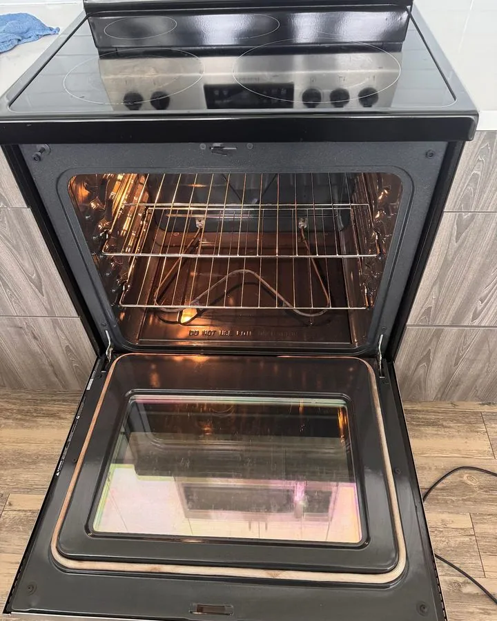 Open oven with clean racks and door glass